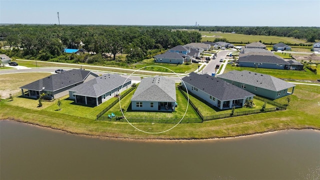 drone / aerial view featuring a residential view and a water view