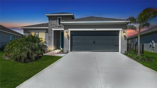 11869 Richmond Trl, Parrish, FL 34219 - view of front of property featuring a garage, stucco siding, concrete driveway, and stone siding