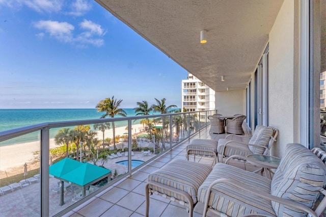 balcony with a beach view and a water view