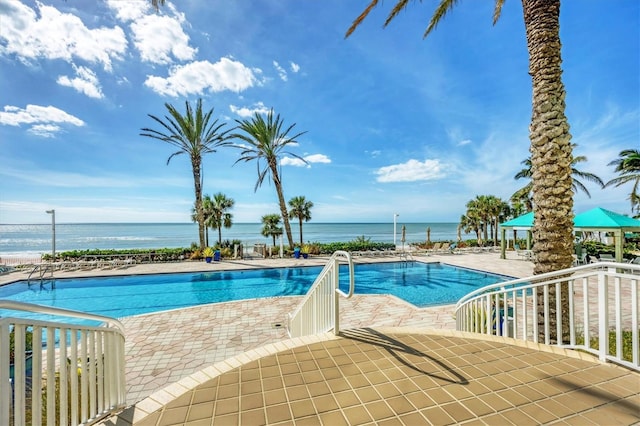 pool featuring a patio, a gazebo, and a water view