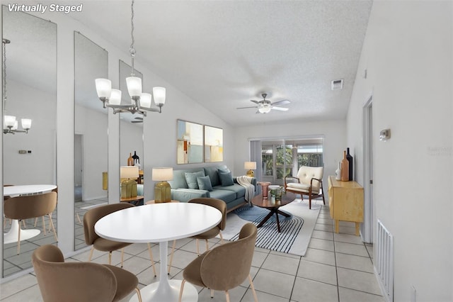 5382 Royal Palm Ave Unit 5382, Sarasota, FL 34234 - dining space featuring a chandelier, vaulted ceiling, ceiling fan, light tile patterned floors, and a textured ceiling