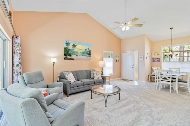 6339 Bay Cedar Ln Unit 102, Bradenton, FL 34203 - living area featuring light colored carpet, high vaulted ceiling, baseboards, and ceiling fan with notable chandelier