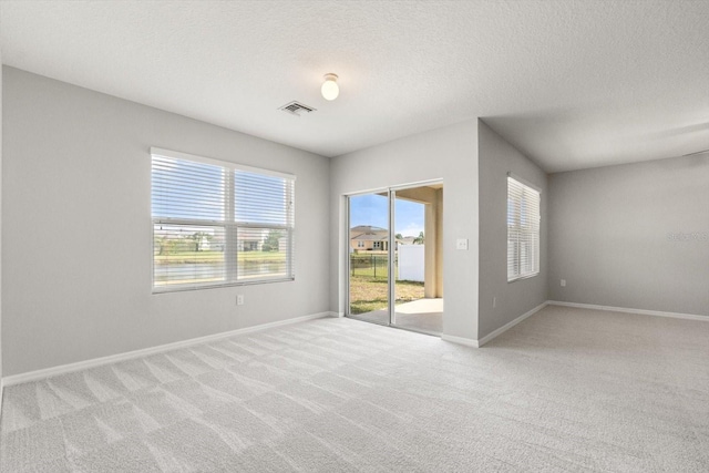 14914 Flowing Gold Dr, Bradenton, FL 34212 - empty room with light carpet, baseboards, and a textured ceiling