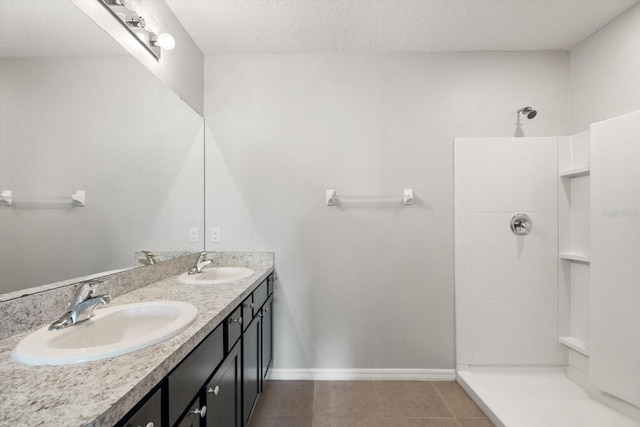 14914 Flowing Gold Dr, Bradenton, FL 34212 - full bath with double vanity, a shower, baseboards, a textured ceiling, and tile patterned floors