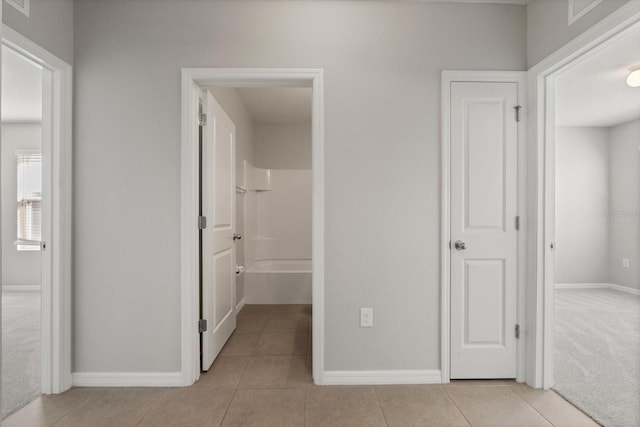 14914 Flowing Gold Dr, Bradenton, FL 34212 - hallway featuring baseboards and light tile patterned floors