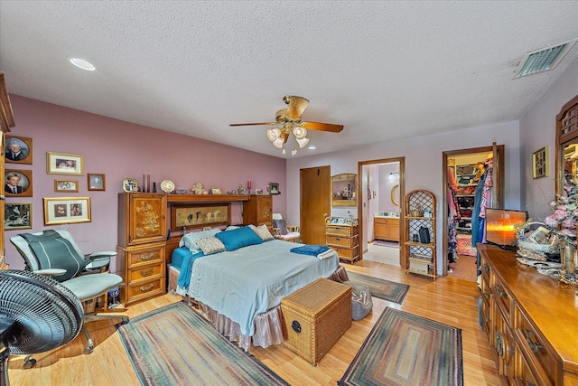 4053 Lancaster Dr, Sarasota, FL 34241 - bedroom featuring a walk in closet, a textured ceiling, visible vents, and light wood finished floors
