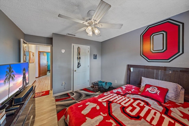 4053 Lancaster Dr, Sarasota, FL 34241 - bedroom featuring ceiling fan, wood finished floors, visible vents, and a textured ceiling
