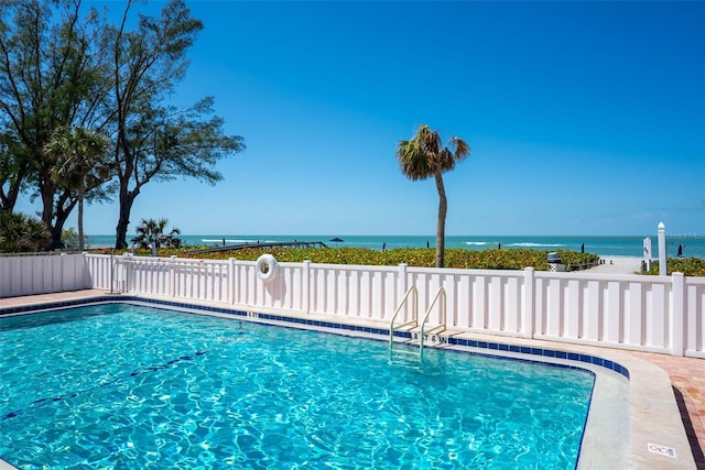 pool featuring fence and a water view