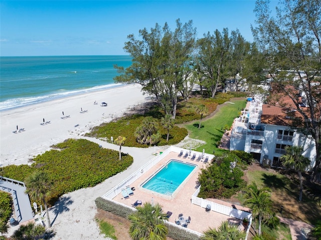 drone / aerial view with a beach view and a water view