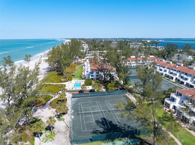 birds eye view of property with a beach view and a water view