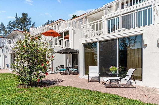 5055 Gulf Of Mexico Dr Unit 414, Longboat Key, FL 34228 - back of house with a balcony, a patio, and stucco siding