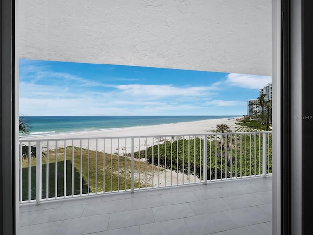 balcony with view of water and beach