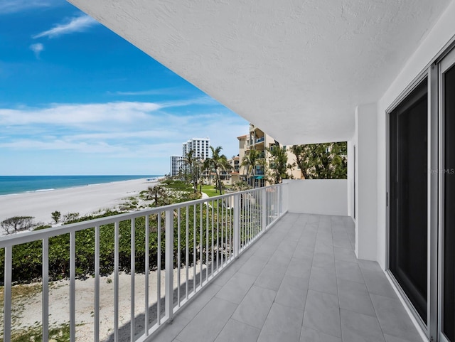 balcony with view of water and beach