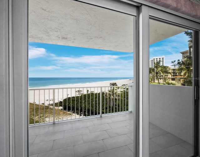 balcony featuring view of water and beach