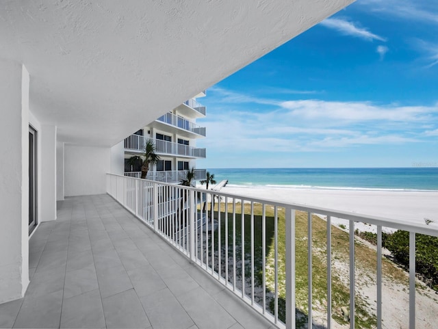 balcony featuring view of water and beach