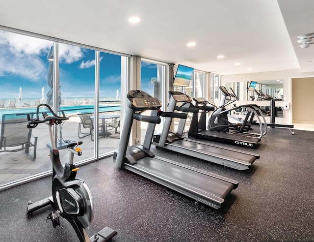 exercise room featuring plenty of natural light, recessed lighting, and a wall of windows