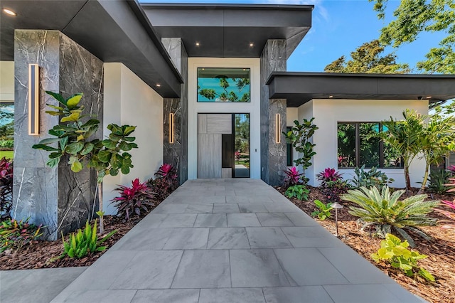 property entrance featuring stucco siding