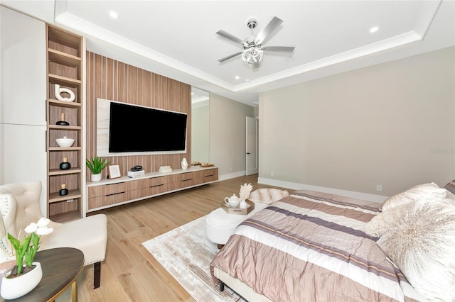 bedroom with baseboards, recessed lighting, light wood-style floors, and a raised ceiling
