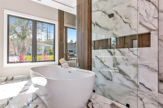 full bath with a freestanding tub, marble finish floor, and a marble finish shower