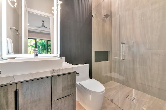 full bathroom featuring a shower stall, toilet, and vanity