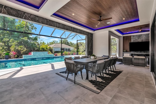 exterior space featuring an outdoor living space, a ceiling fan, glass enclosure, and a patio