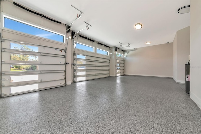 garage featuring water heater and baseboards