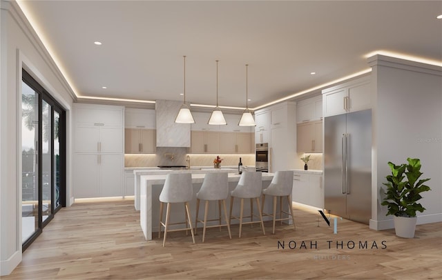 kitchen with light countertops, a large island, backsplash, and stainless steel appliances