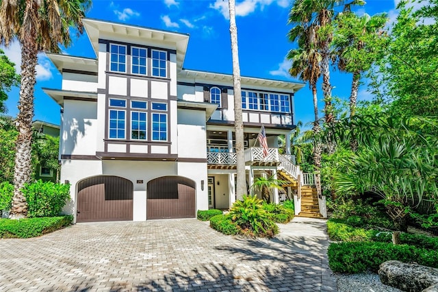 103 Park Ave, Anna Maria, FL 34216 - view of front of property featuring an attached garage, stairs, stucco siding, and driveway