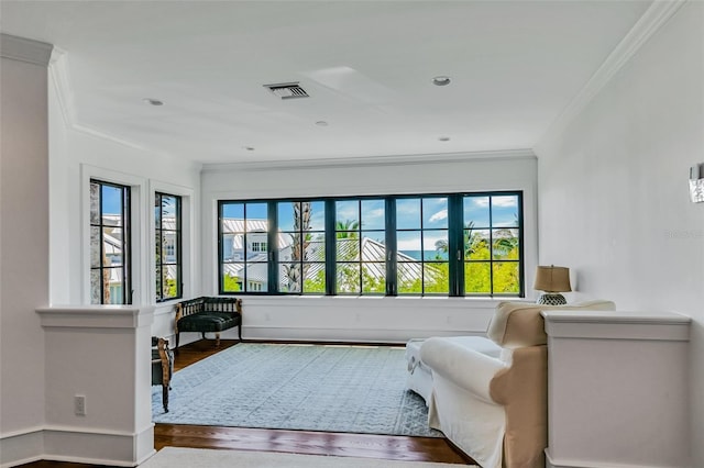 103 Park Ave, Anna Maria, FL 34216 - sitting room with wood finished floors, visible vents, a wealth of natural light, and ornamental molding