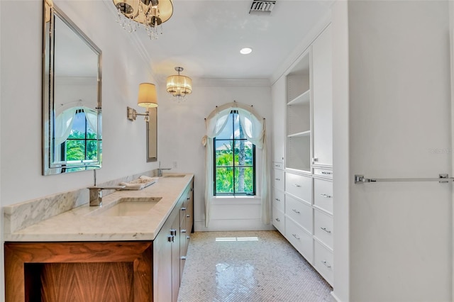 103 Park Ave, Anna Maria, FL 34216 - bathroom with double vanity, a sink, a chandelier, and ornamental molding