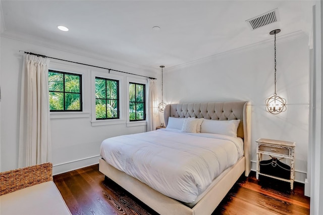 103 Park Ave, Anna Maria, FL 34216 - bedroom with baseboards, ornamental molding, dark wood-type flooring, and visible vents