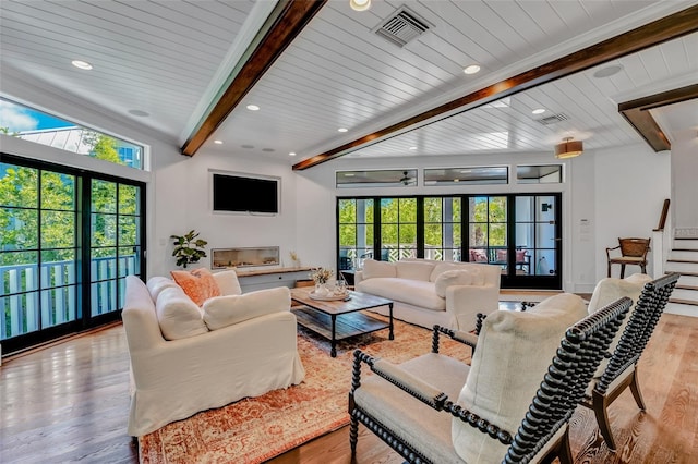 103 Park Ave, Anna Maria, FL 34216 - living room featuring beamed ceiling, wood finished floors, visible vents, and a wealth of natural light