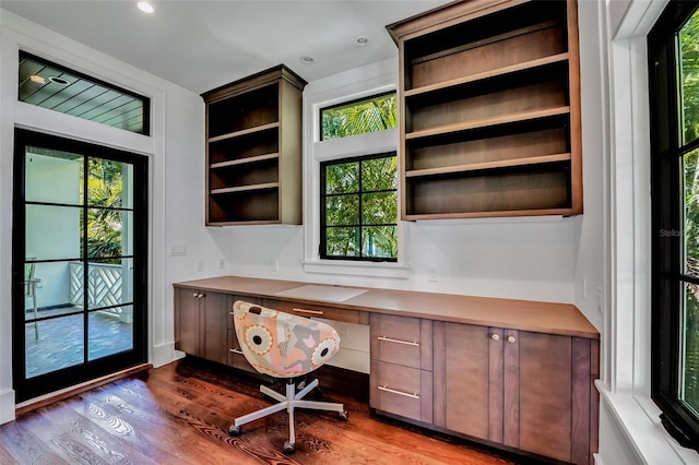 103 Park Ave, Anna Maria, FL 34216 - home office featuring recessed lighting, built in study area, wood finished floors, and a healthy amount of sunlight