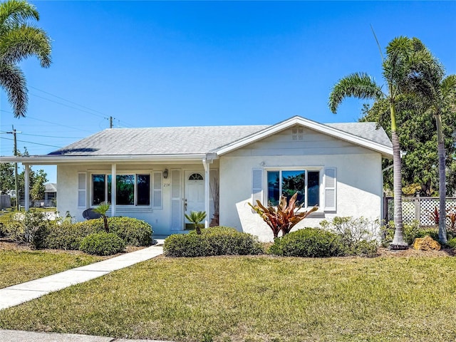 214 49th St W, Bradenton, FL 34209 - view of front of home with roof with shingles, a front yard, and stucco siding