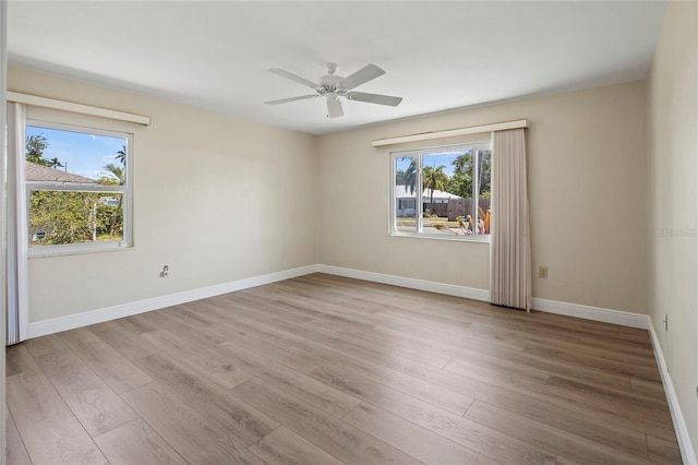 214 49th St W, Bradenton, FL 34209 - spare room with baseboards, a wealth of natural light, a ceiling fan, and light wood-type flooring