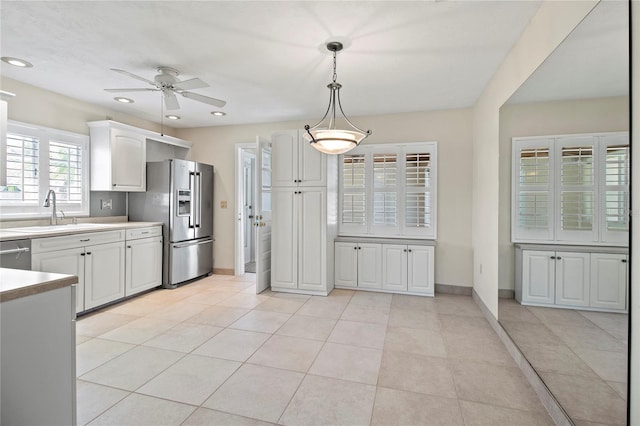 214 49th St W, Bradenton, FL 34209 - kitchen featuring a ceiling fan, a sink, hanging light fixtures, light countertops, and appliances with stainless steel finishes