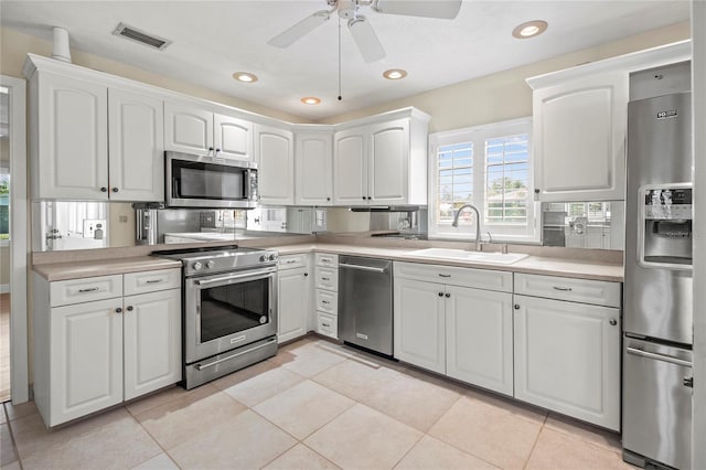 214 49th St W, Bradenton, FL 34209 - kitchen with a sink, visible vents, a ceiling fan, light countertops, and appliances with stainless steel finishes