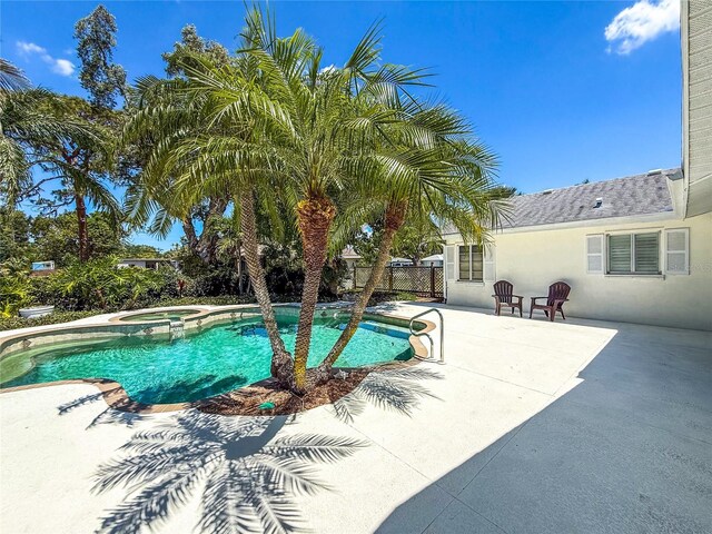 214 49th St W, Bradenton, FL 34209 - view of pool featuring a patio area, a pool with connected hot tub, and fence