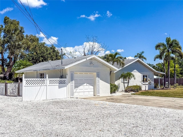214 49th St W, Bradenton, FL 34209 - ranch-style home with a garage, stucco siding, concrete driveway, and fence