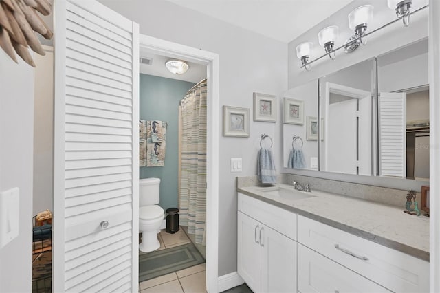 bathroom with vanity, toilet, tile patterned flooring, and visible vents