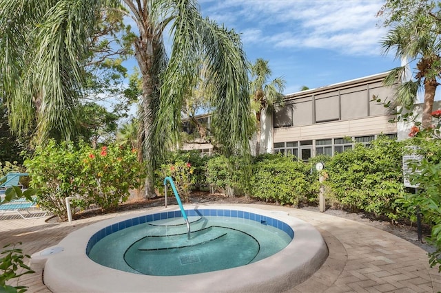 view of pool with a hot tub