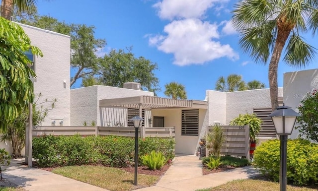 exterior space featuring a fenced front yard and stucco siding