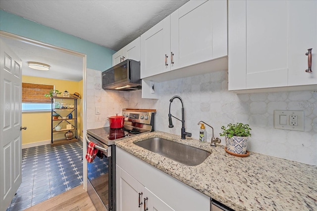130 E Seminole Dr, Venice, FL 34293 - kitchen featuring white cabinets, tasteful backsplash, stainless steel electric range oven, and a sink