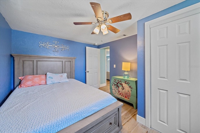 130 E Seminole Dr, Venice, FL 34293 - bedroom with visible vents, baseboards, ceiling fan, a textured ceiling, and light wood finished floors