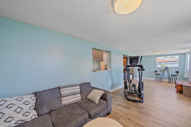 130 E Seminole Dr, Venice, FL 34293 - living area with a textured ceiling, wood finished floors, and baseboards