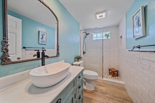 130 E Seminole Dr, Venice, FL 34293 - full bath featuring a tile shower, vanity, wood finished floors, and a textured ceiling