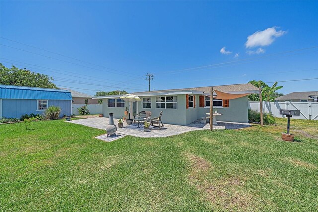 130 E Seminole Dr, Venice, FL 34293 - back of property featuring a yard, fence, a patio, and stucco siding