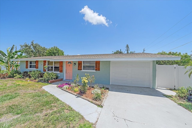 130 E Seminole Dr, Venice, FL 34293 - ranch-style house featuring stucco siding, a front yard, fence, a garage, and driveway