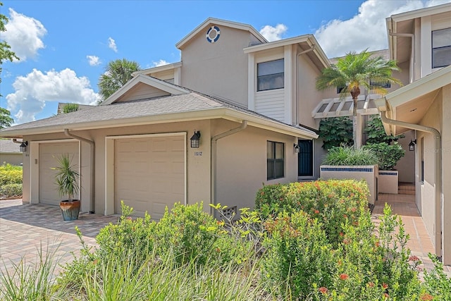 1612 Starling Dr Unit 101, Sarasota, FL 34231 - view of front of house featuring driveway, stucco siding, and a garage