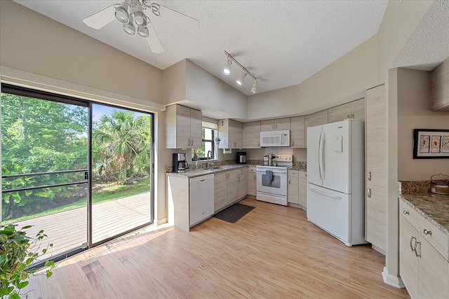 1612 Starling Dr Unit 101, Sarasota, FL 34231 - kitchen featuring a sink, ceiling fan, light wood-type flooring, white appliances, and rail lighting